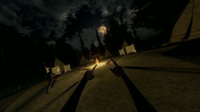 Tents around a campfire under a full moon